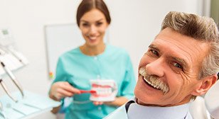 Senior man smiling at dentist