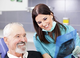 Dentist and patient looking at x-ray