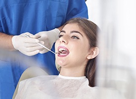 Woman receiving oral cancer screening