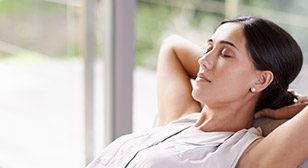 Relaxing woman with hands behind head