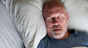 Man sleeping soundly in bed