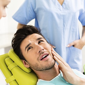 Man in pain holding jaw